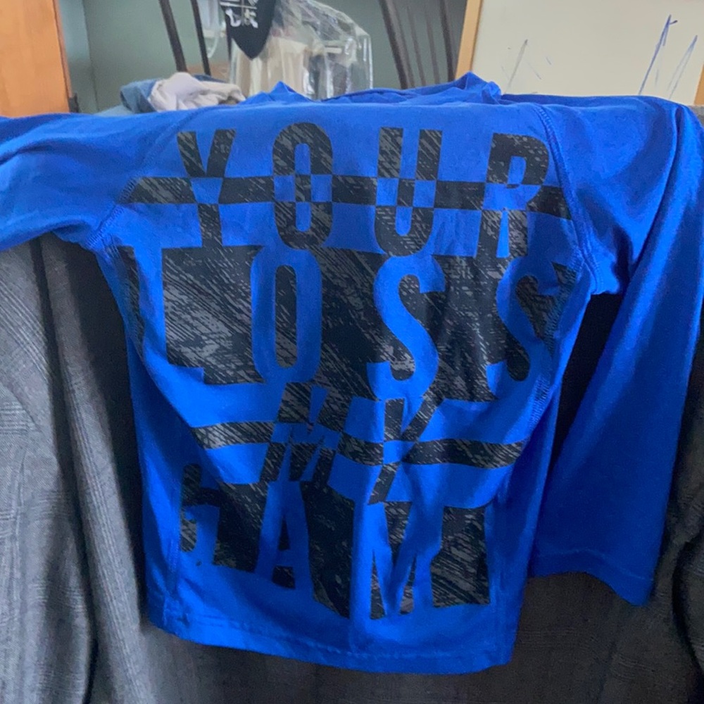 Champion brand blue boy long-sleeve shirt. “your loss my game” is what it says
